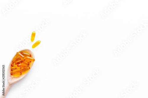 Reception of medicines concept. Pills in spoon on white background top view space for text