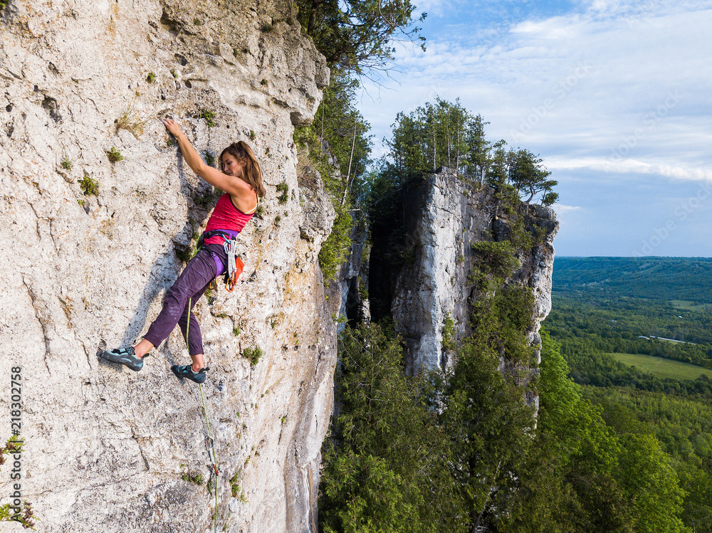 A beautiful woman rock climbing in Ontario, Canada.