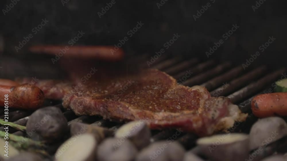 Adjusting Steak on Grill with Tongs Adjusting Steak on Grill with Tongs