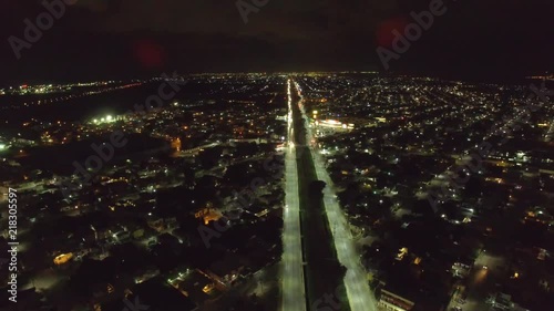 AERIAL SHOT OVER A CITY AT NIGHT SPEED UP, TIMELAPSE. photo