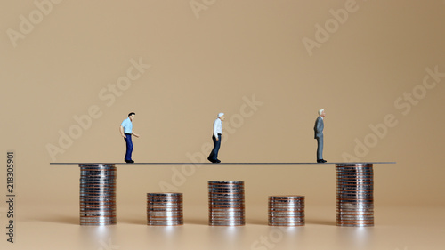 Coins of different heights with miniature people.  photo