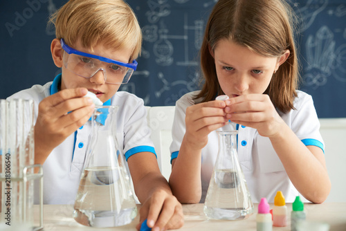 School children are excited to add color reagents into beakers with water