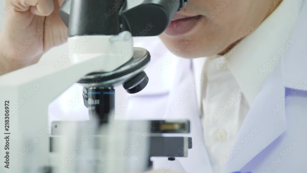 Medical research scientists in laboratory looking through a microscope. Medical research scientists in laboratory looking through a microscope.