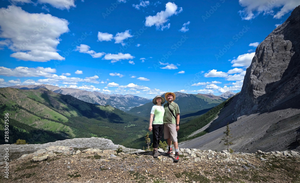 Happy married couple middle age hiking in Canadian Rocky Mountains. West Wind Pass trail in Kananaskis country near Canmore. Alberta. Canada.