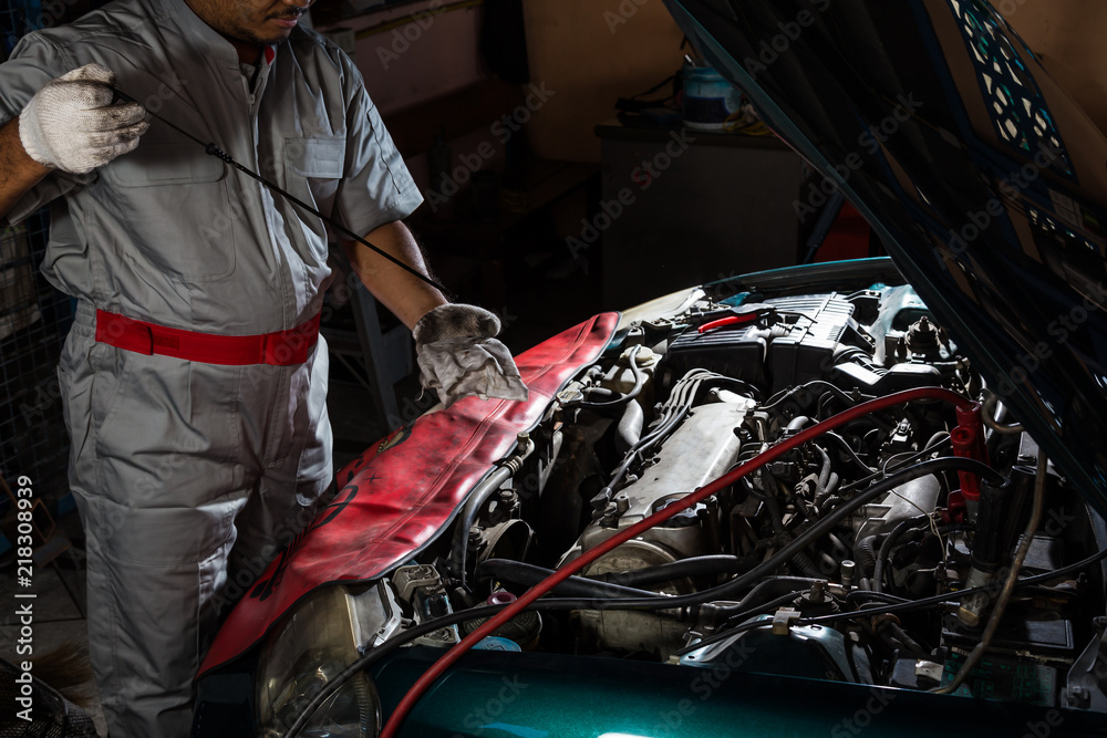 Auto mechanic checking oil,car repair service Auto mechanic checking oil,car repair service