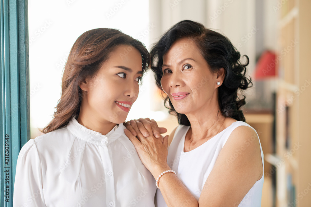 Pretty middle-aged Vietnamese woman and her beautiful adult daughter