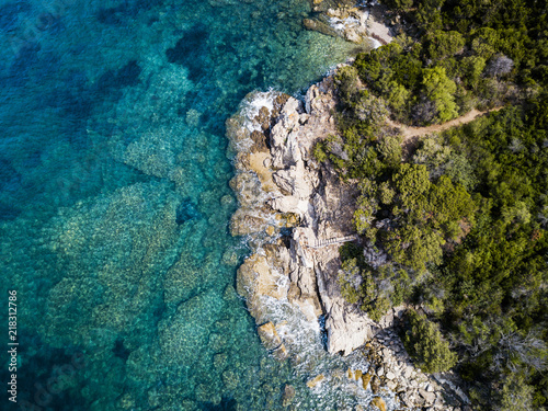 Aerial view of an amazing rocky and green coast bathed by a transparent and turquoise sea. Sardinia, Italy. © Travel Wild