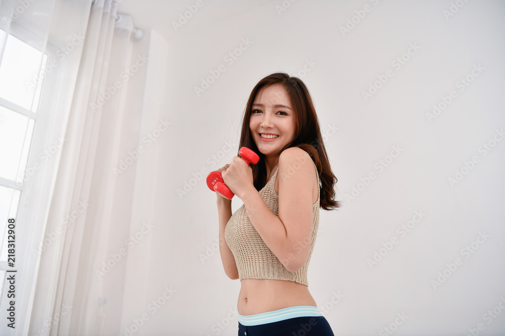 Concept of exercise. Beautiful girl is exercising in her house. Beautiful girl takes good care of her health. Concept of exercise. Beautiful girl is exercising in her house. Beautiful girl takes good care of her health.