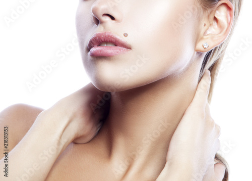 Part of beauty face of girl model. Natural nude make-up, beauty spot near mouth, hands near neck. Skincare facial treatment concept photo