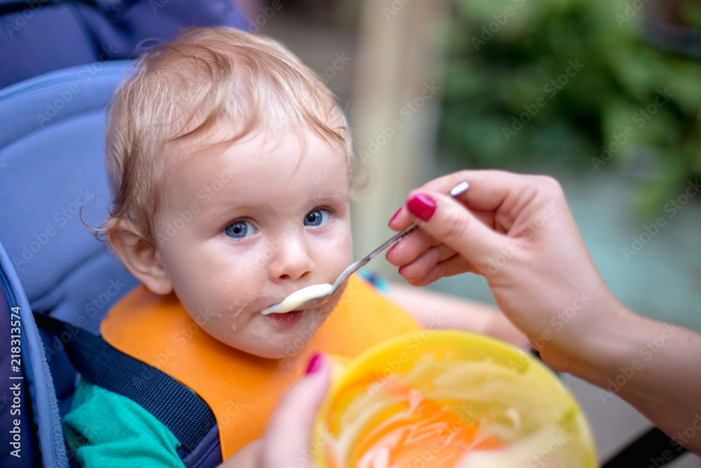 A small cute baby eats in a baby stroller A small cute baby eats in a baby stroller