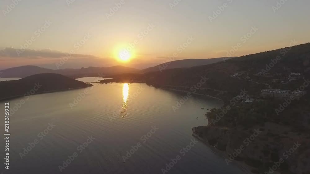 Greek beach at sunset DURING SUMMER Greek beach at sunset DURING SUMMER