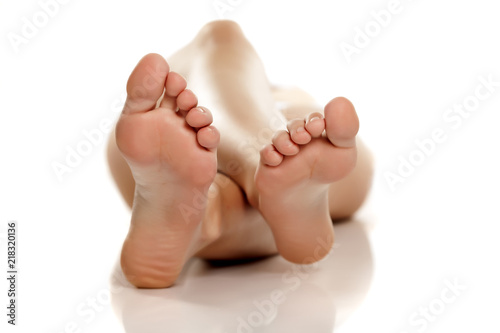 Photography female bare feet on white background