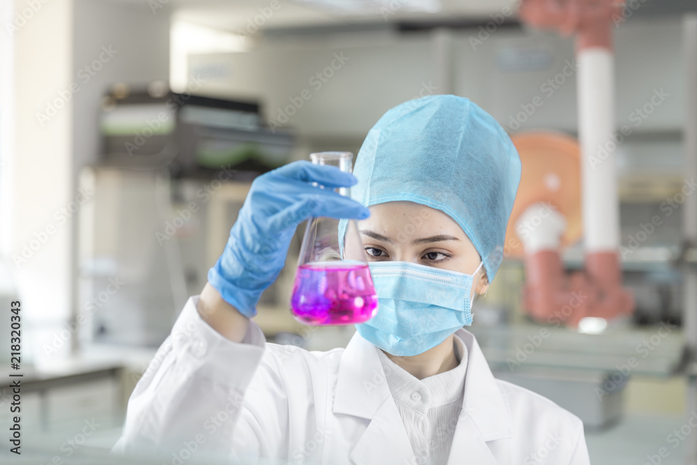 Female scientist looking at the sample in the laboratory Female scientist looking at the sample in the laboratory