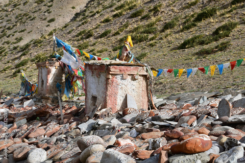 Tibet. Ancient stupa and buddhist prayer stones with mantras and ritual drawings on the trail from the town of Dorchen around mount Kailash