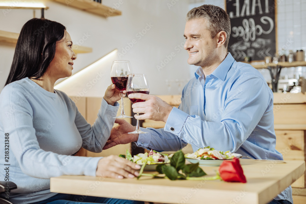 Good mood. Wonderful lovely couple spending time in a restaurant while discussing daily issues Good mood. Wonderful lovely couple spending time in a restaurant while discussing daily issues