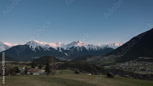 Time lapse of sunrise over Alps by the village Arzl in Pitztal, Tyrol, Austria photo