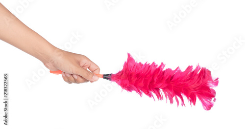 Fotografie Hand holding pink plastic feather duster isolated on white background