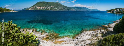 Panorama of crystal clear transparent blue turquoise teal Mediterranean seascape in Fiskardo town. Kefalonia, Ionian islands, Greece © Igor Tichonow