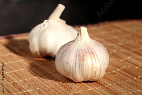 Two Bulbs of Fresh Garlic on Bamboo Mat
