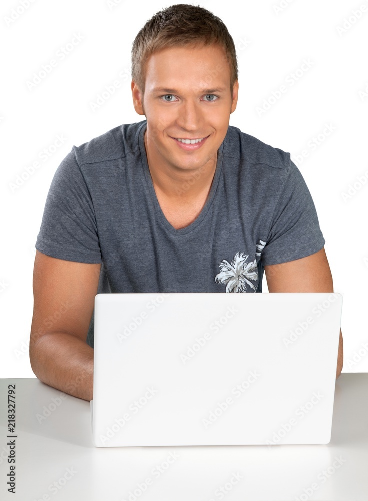 Portrait of young man using laptop isolated on white background Portrait of young man using laptop isolated on white background