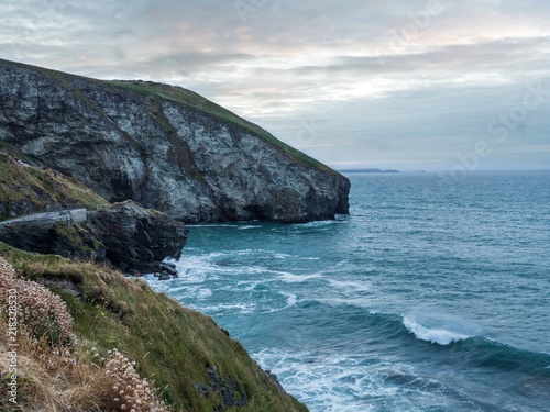 Looking down at the waves crashing on the coast in Trebarwith Strand, Cornwall photo