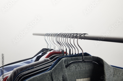 selective focus of different shirts on hangers isolated on white