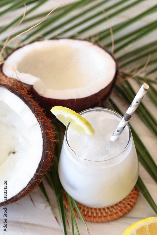 Coconut cocktail in glasses with lemon and drinking straw. White background. Copy space Coconut cocktail in glasses with lemon and drinking straw. White background. Copy space