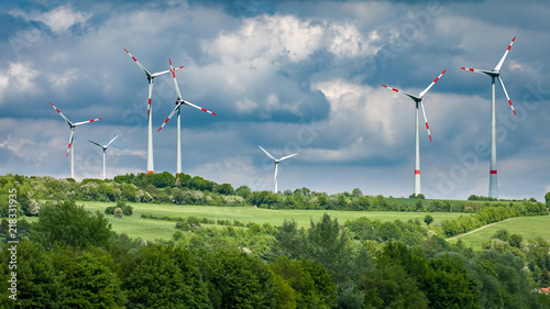 Wind trubines in green fields photo