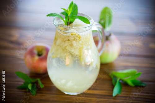 summer sweet cold compote of fresh apples with a sprig of mint