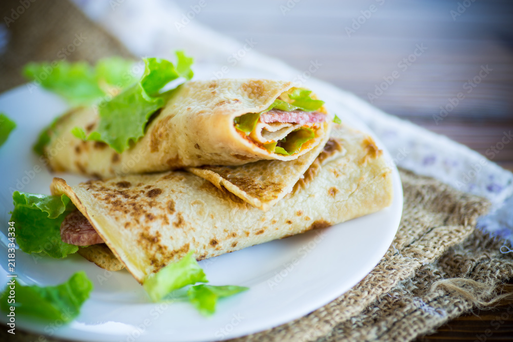 thin pancakes with salad leaves and bacon in a plate thin pancakes with salad leaves and bacon in a plate