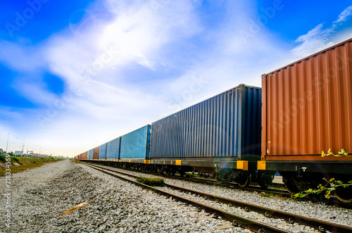 Container on train ,rail way on small stone is waiting for sent to seaport in blue sky is so beautiful sky this image for import and export logistic concept