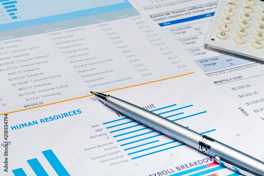 Pen and Calculator on Business Graphs and Charts Pen and Calculator on Business Graphs and Charts