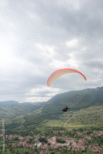 Parachute flying over the village Rimetea, Romania