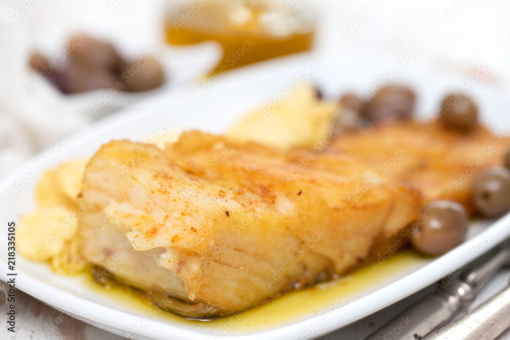 fried cod fish with olive oil on dish fried cod fish with olive oil on dish