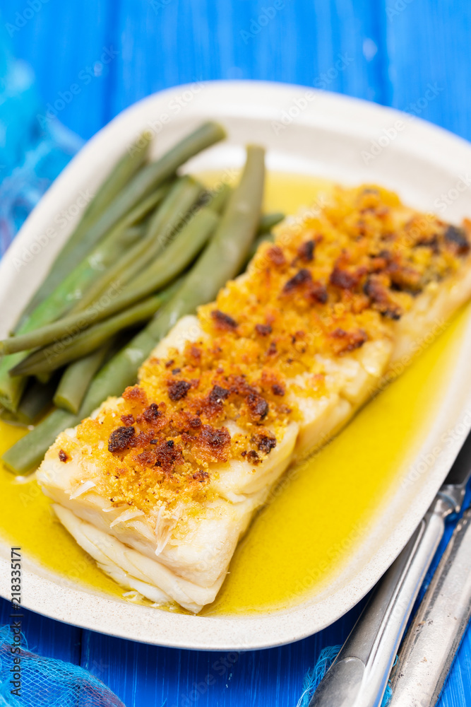 cod fish with corn bread and green beans on dish cod fish with corn bread and green beans on dish