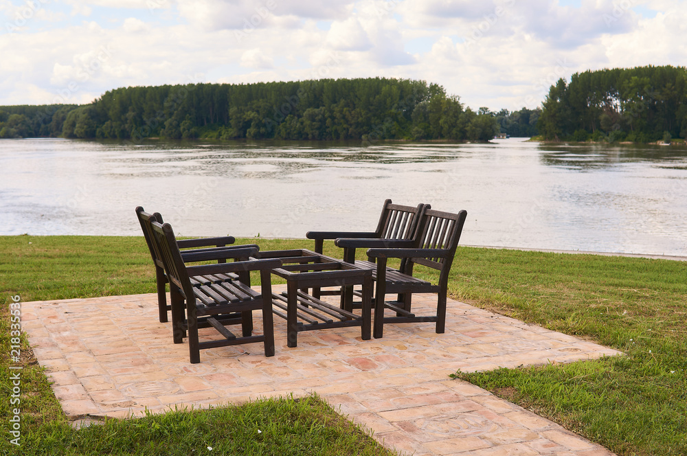 Wooden table and chairs for four people to enjoy near river Danube. 