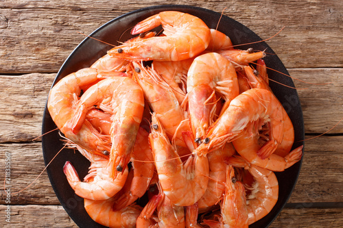 dish with boiled king prawns close-up on a plate. Food background. horizontal top view