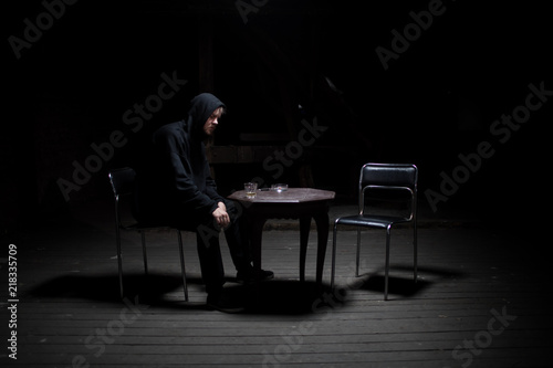 Dangerous man sitting alone in the dark