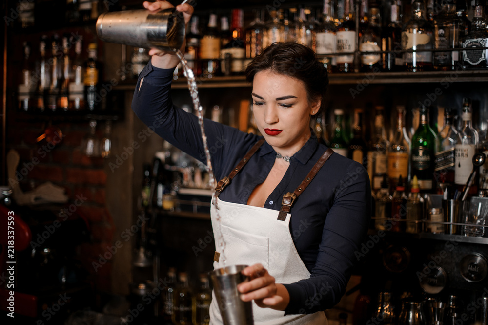 Beautiful sexy barmaid making a fresh summer cocktail Beautiful sexy barmaid making a fresh summer cocktail