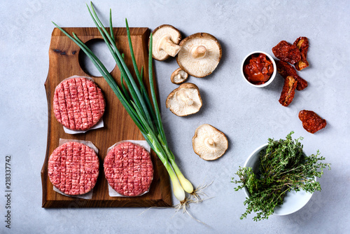 Fototapeta Naklejka Na Ścianę i Meble -  Raw fresh marbled minced meat Steak,seasonings on grey background