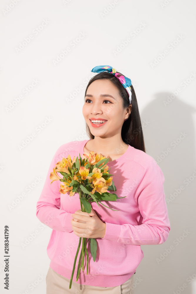 Toothy smiling happy woman holding flower . White background isolated portrait. Toothy smiling happy woman holding flower . White background isolated portrait.