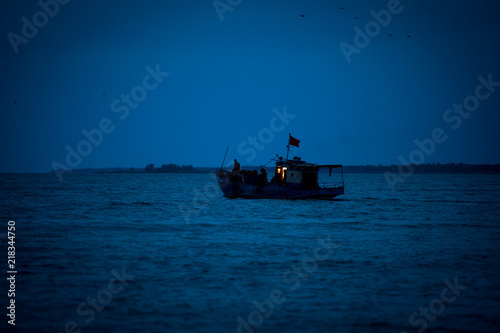 Fishing boat goes to sea. Ship at sea. Seiner goes to sea.  A ship at dawn in the sea. Fishing boat at night at sea.
