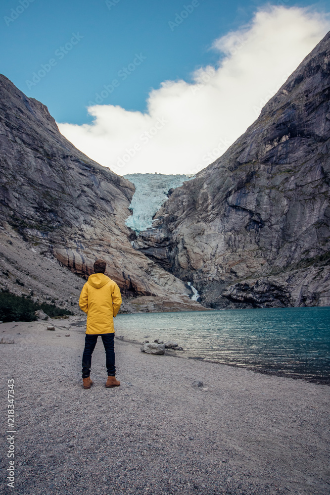 tourist in front of a glacier