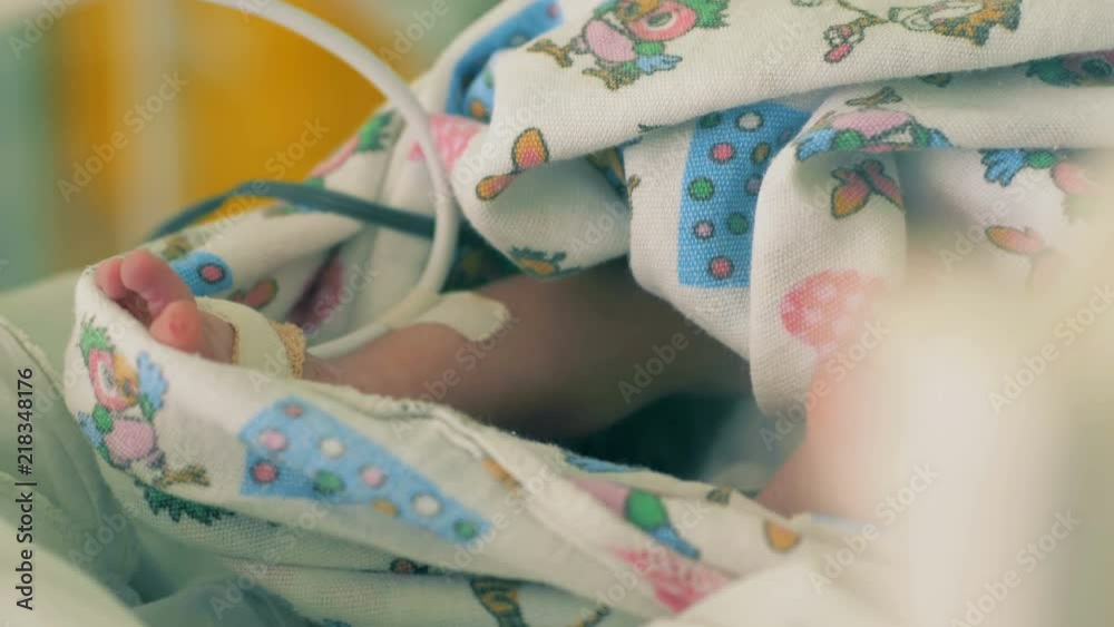 Baby's feet with tubes, close up. Baby's feet with tubes, close up.