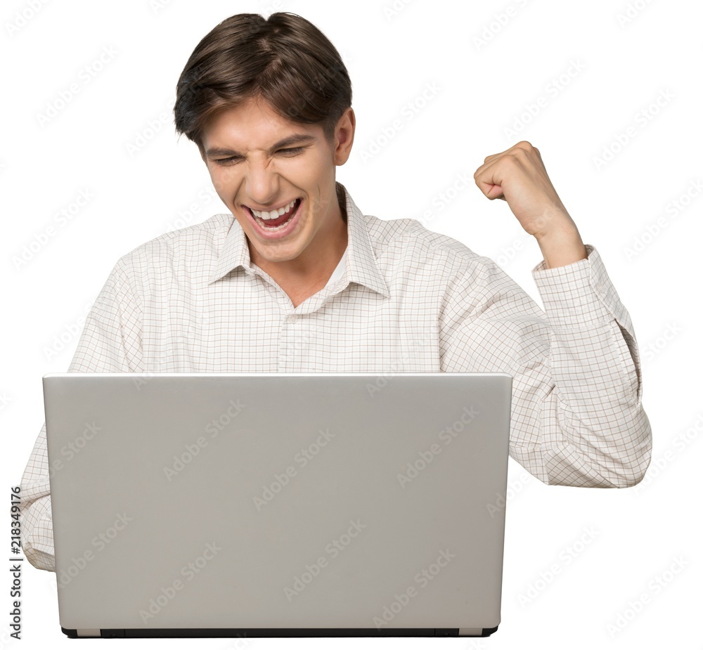 Portrait of Young Man Using Laptop with Fist Raised Portrait of Young Man Using Laptop with Fist Raised