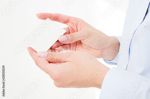 female hand holding business card isolated on white background. Copy space photo