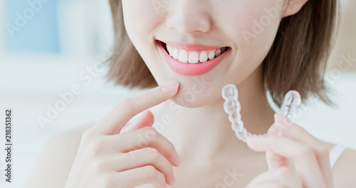 woman take invisible braces photo