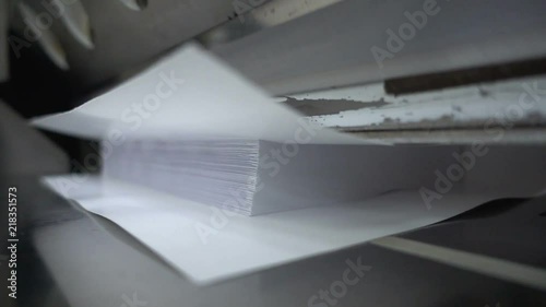 Paper cutting process, close-up, big industrial cutter for cutting paper shears - guillotine machine. Slow motion 250FPS