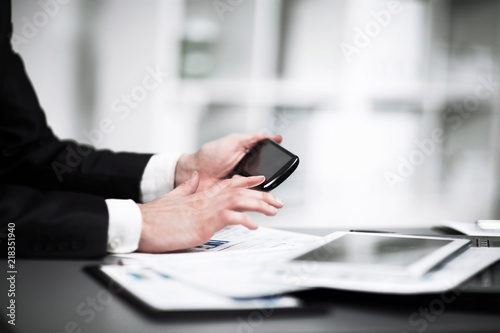 businessman hand use smart phone in the office