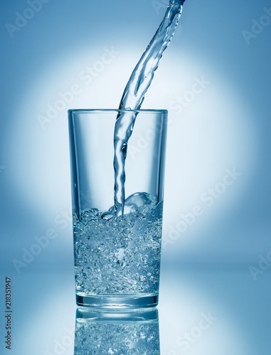 Pouring soda water into glass